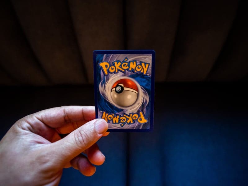 A person holding a collectible trading card
