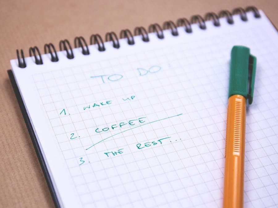 A notebook and pen on a desk ready for planning