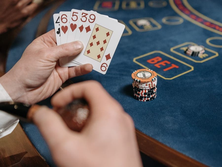 A person holding a trading card at a table