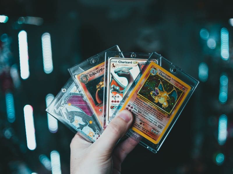 A hand holding collectible trading cards