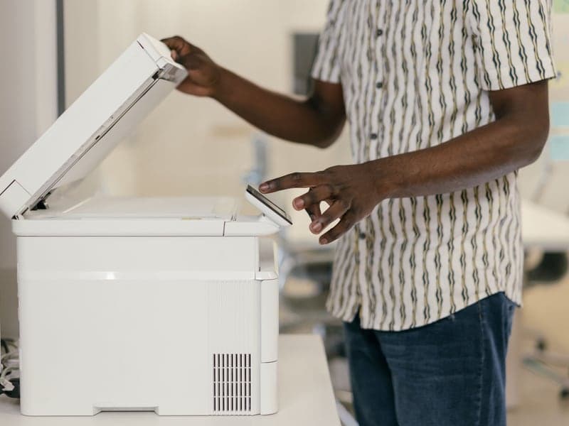 A person operating office equipment to copy documents